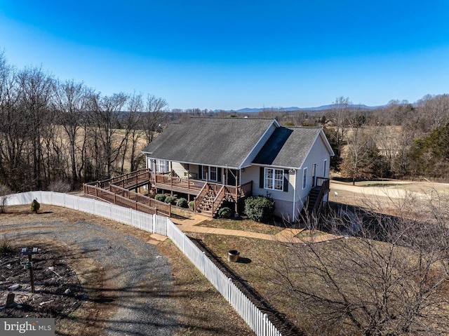 view of front of property featuring fence private yard and stairway