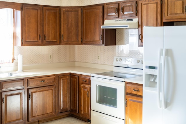 kitchen featuring sink and white appliances