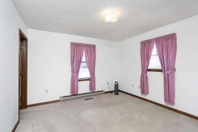 carpeted empty room with a textured ceiling and wood walls