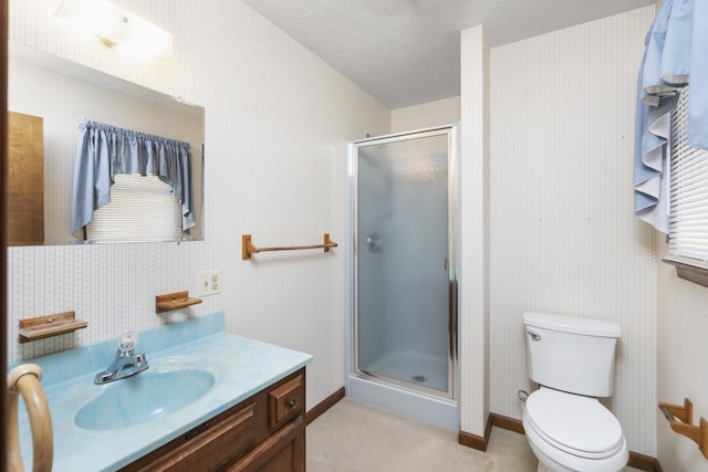 bathroom with vanity, an enclosed shower, a textured ceiling, and toilet