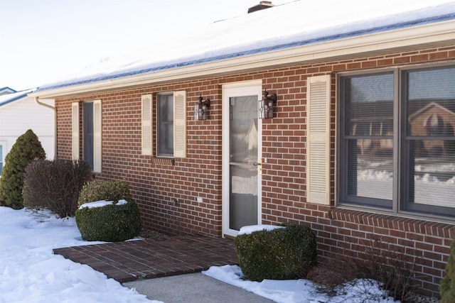 view of snow covered property entrance