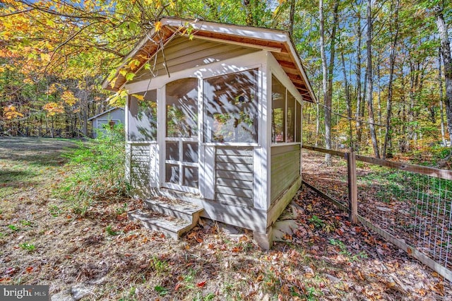 view of outbuilding featuring a sunroom