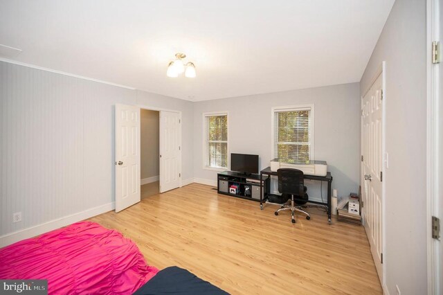 home office with light hardwood / wood-style flooring