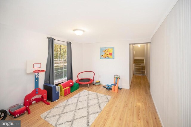 playroom featuring baseboards and wood finished floors