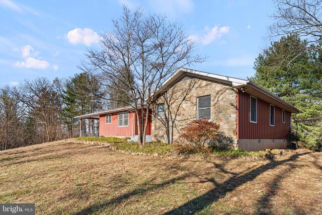 view of side of home featuring a lawn