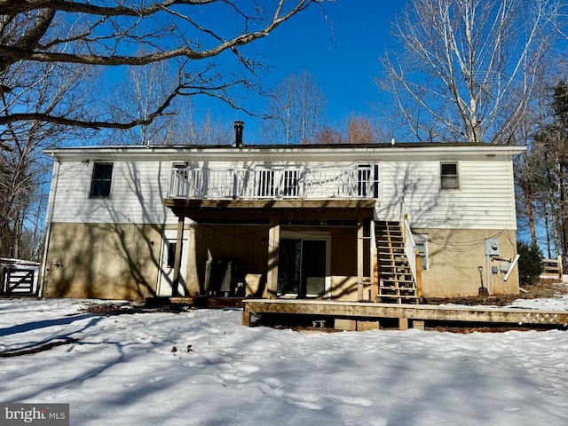 snow covered property with a wooden deck