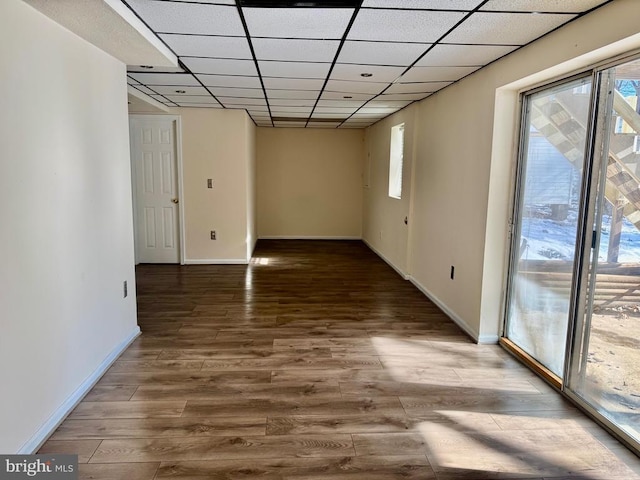 unfurnished room featuring hardwood / wood-style floors and a paneled ceiling