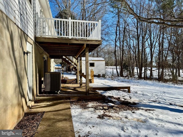 exterior space with a deck, central air condition unit, and a shed