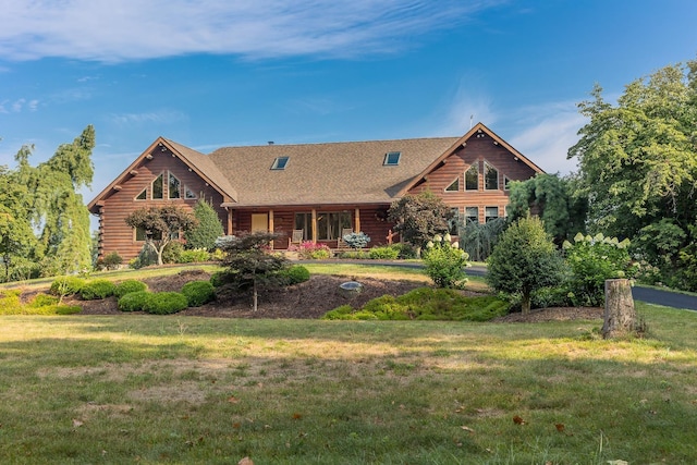 cabin featuring a front lawn