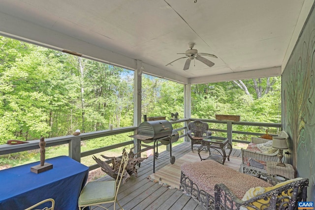deck featuring grilling area and a ceiling fan