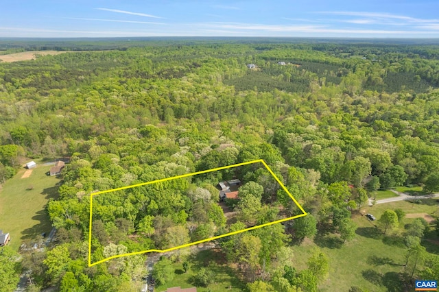 drone / aerial view featuring a wooded view