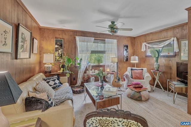carpeted living room with plenty of natural light and wood walls