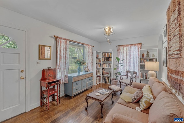 living area with baseboards and hardwood / wood-style floors