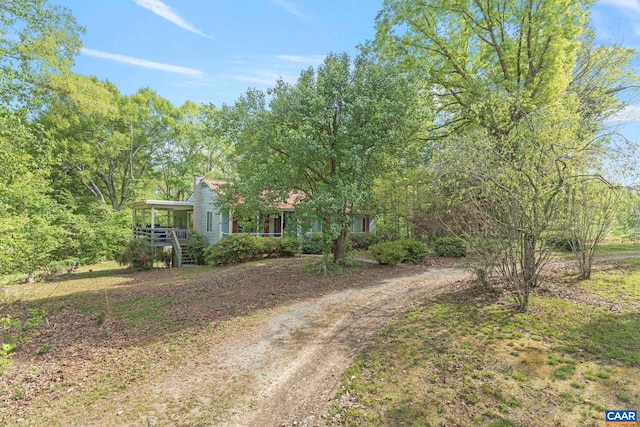 obstructed view of property with covered porch and driveway