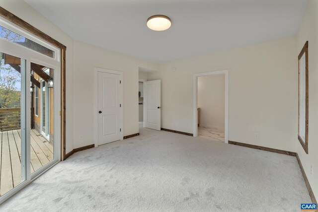 unfurnished bedroom with light colored carpet