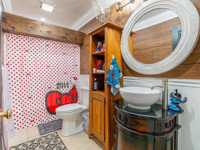 bathroom featuring tile patterned flooring, vanity, ornamental molding, and toilet