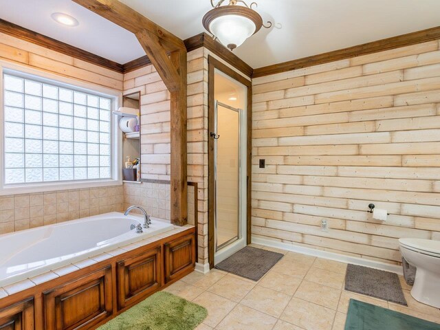 bathroom featuring toilet, tile patterned floors, and shower with separate bathtub