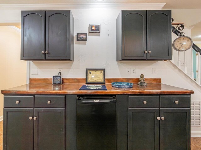 bar with ornamental molding and butcher block countertops