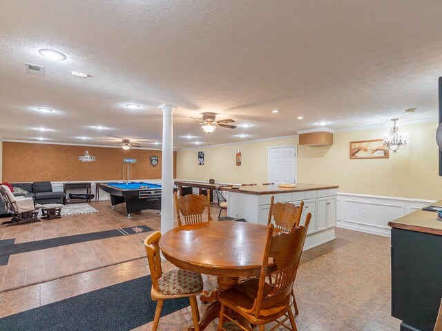 rec room featuring crown molding, ceiling fan, decorative columns, a textured ceiling, and pool table