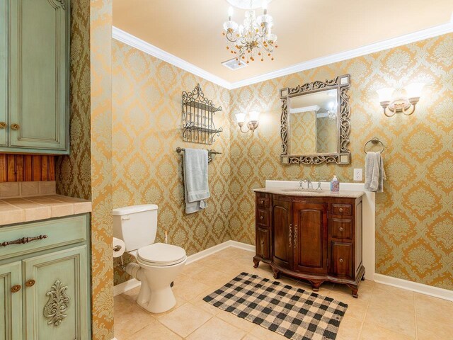 bathroom with crown molding, vanity, a notable chandelier, tile patterned floors, and toilet