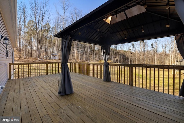 deck featuring a gazebo and a forest view