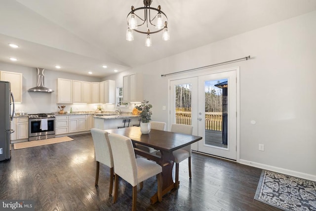 dining room featuring a notable chandelier, dark wood finished floors, recessed lighting, french doors, and lofted ceiling