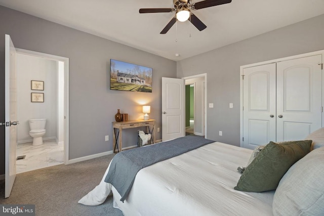 bedroom featuring a ceiling fan, a closet, connected bathroom, carpet, and baseboards