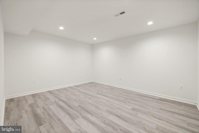 spare room with recessed lighting, visible vents, light wood finished floors, and baseboards