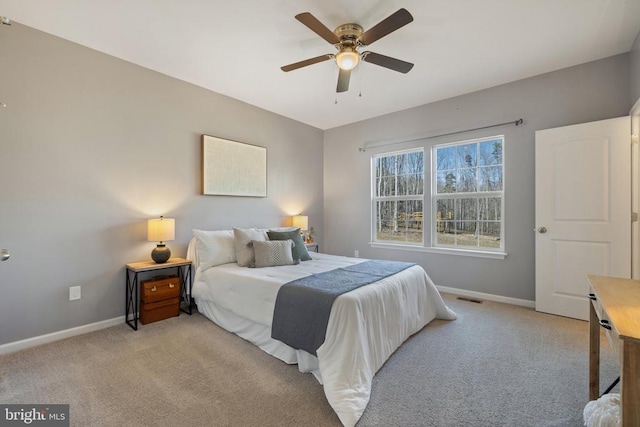 bedroom with baseboards, light carpet, and visible vents