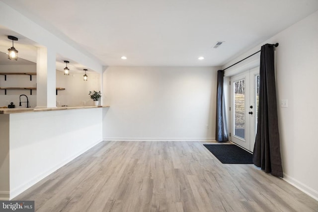 interior space featuring recessed lighting, baseboards, and wood finished floors