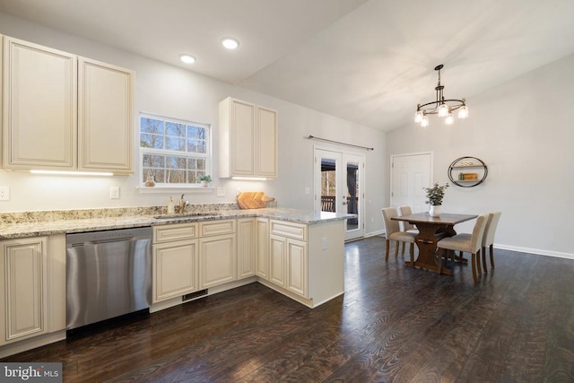 kitchen with a peninsula, a sink, french doors, dishwasher, and cream cabinets