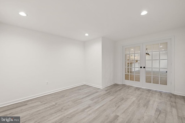 empty room featuring recessed lighting, french doors, baseboards, and wood finished floors