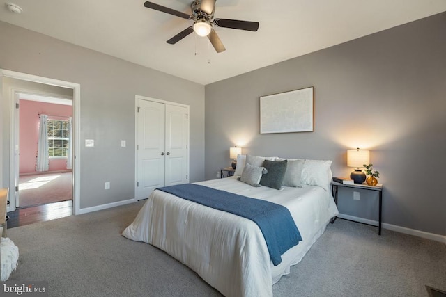 bedroom featuring a closet, baseboards, carpet, and a ceiling fan