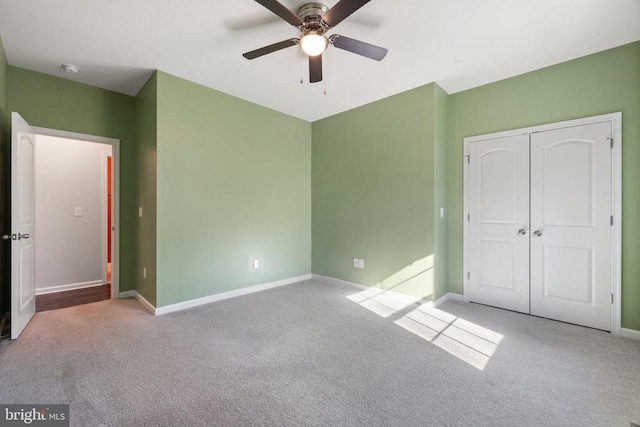 unfurnished bedroom with carpet flooring, baseboards, and a closet