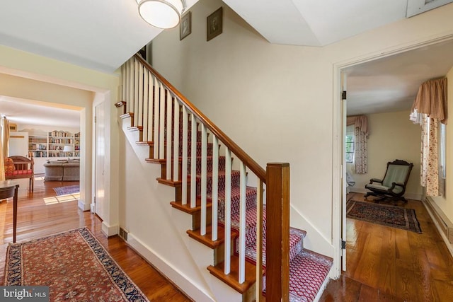stairs featuring baseboards and wood finished floors