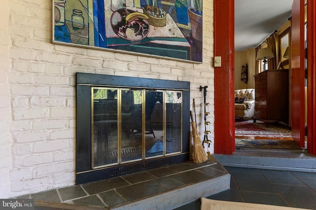interior details featuring a brick fireplace