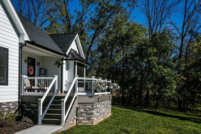 view of side of property with a yard and a porch