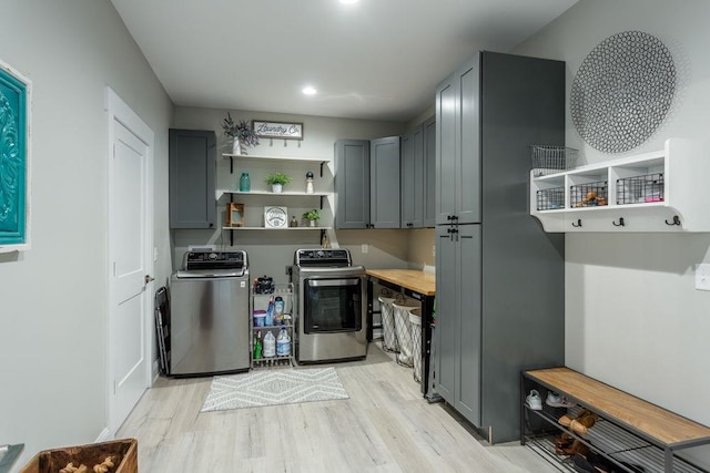 interior space with cabinets, washer and clothes dryer, and light hardwood / wood-style floors