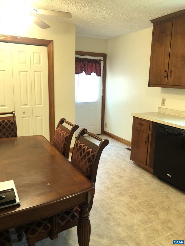 dining space with ceiling fan and a textured ceiling