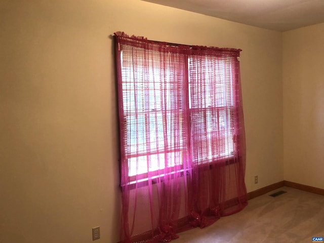 unfurnished room featuring carpet