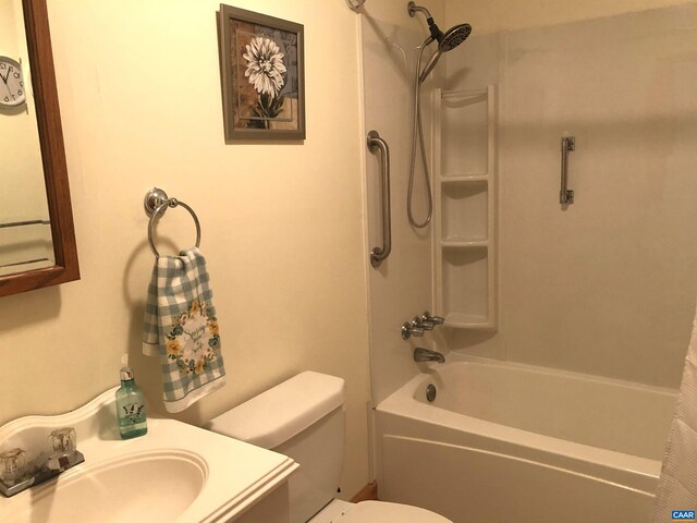 full bathroom with shower / tub combo with curtain, vanity, and toilet