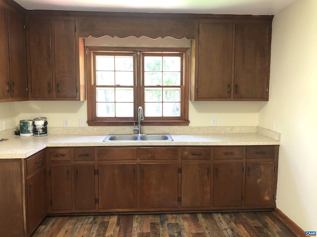 kitchen with dark brown cabinets, sink, and dark hardwood / wood-style floors