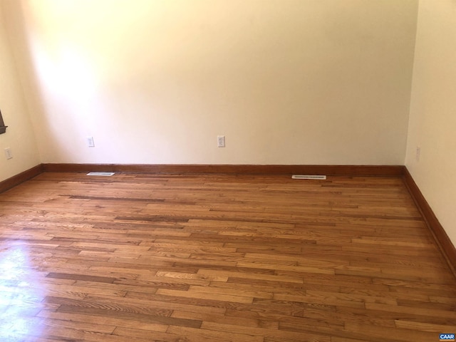 unfurnished room featuring hardwood / wood-style floors