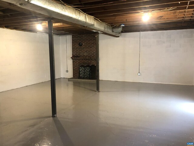 basement with a brick fireplace