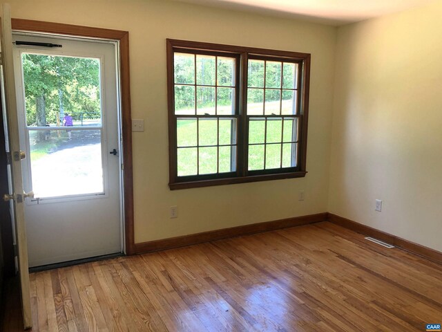 doorway to outside with light wood-type flooring