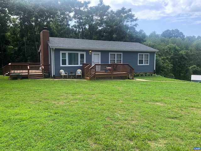 view of front facade with a wooden deck and a front yard