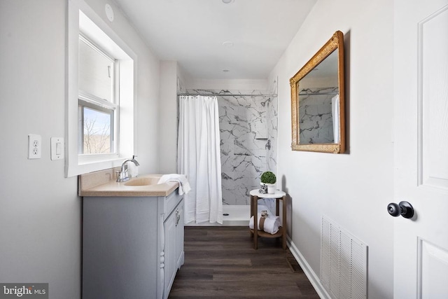 bathroom with vanity, wood-type flooring, and curtained shower