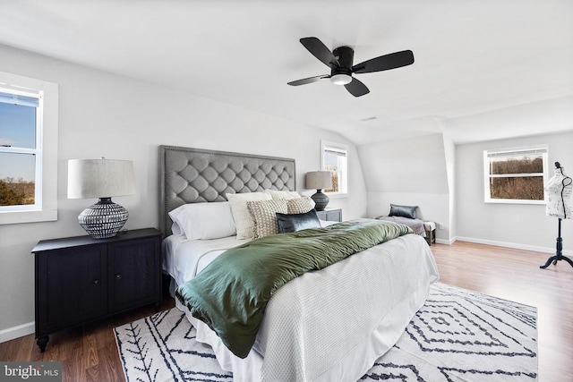 bedroom with ceiling fan, lofted ceiling, and dark hardwood / wood-style flooring