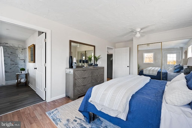 bedroom featuring ceiling fan, dark hardwood / wood-style floors, and a textured ceiling