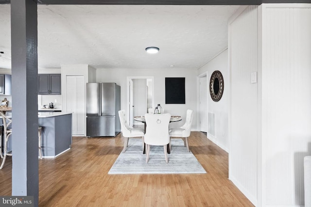 dining space featuring wood-type flooring